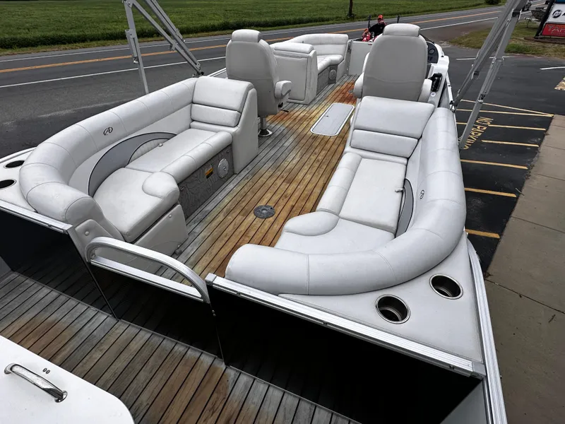 Slide: The Image of 2014 Avalon Catalina Quad Lounge boat with spacious seating and wooden deck. - 10