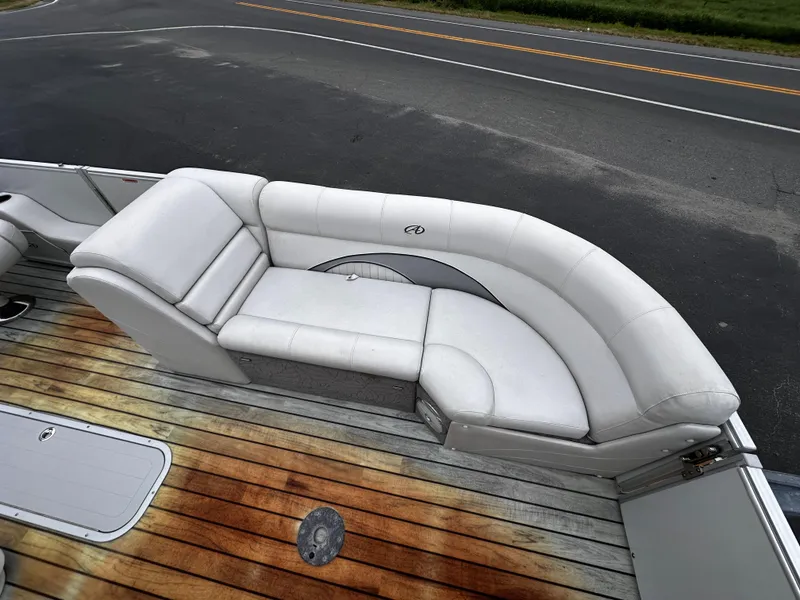Slide: The Image of 2014 Avalon Catalina Quad Lounge boat with white seating and wooden deck. - 14