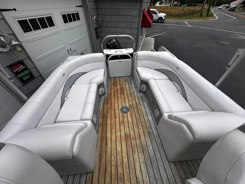 Slide: The Image of 2014 Avalon Catalina Quad Lounge boat with spacious seating and wood deck. - 19
