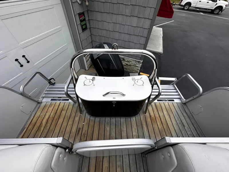 Slide: The Image of 2014 Avalon Catalina Quad Lounge boat interior with wooden deck and seating. - 20
