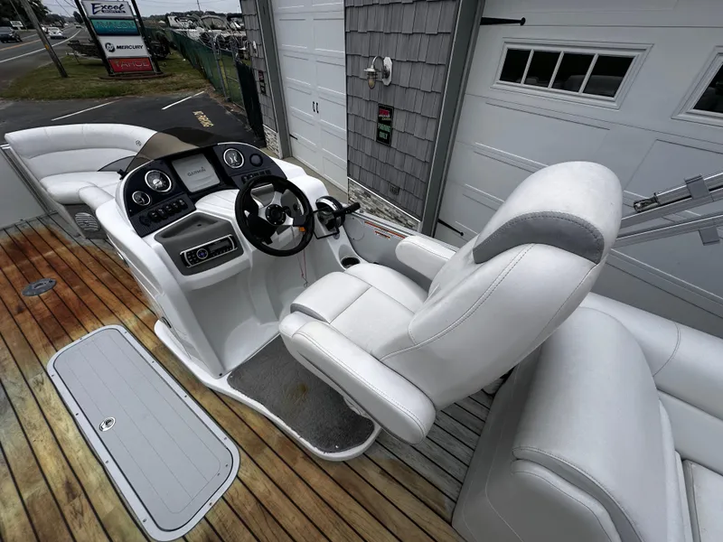 Slide: The Image of 2014 Avalon Catalina Quad Lounge boat interior with white seating and wooden deck. - 21