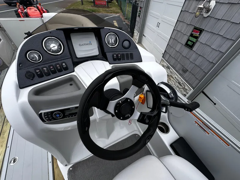 Slide: The Image of 2014 Avalon Catalina Quad Lounge boat dashboard with Garmin navigation system. - 22