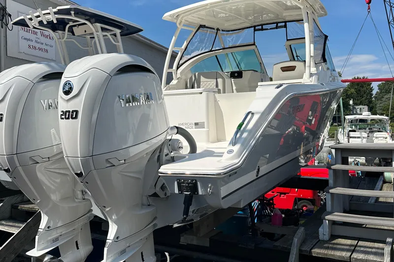 Slide: The Image of 2025 Pursuit DC 266 Dual Console boat with twin Yamaha 200 engines on display. - 5