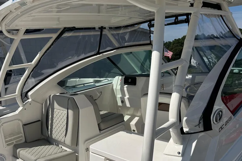 Slide: The Image of 2025 Pursuit DC 266 Dual Console boat interior with seating and helm. - 6