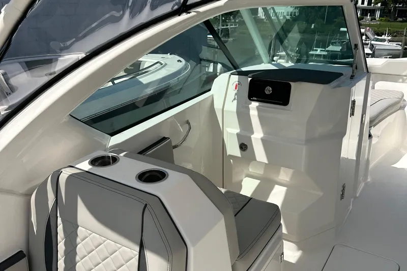 Slide: The Image of 2025 Pursuit DC 266 Dual Console interior with modern seating and sleek design. - 8