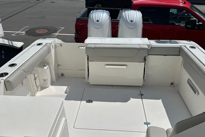 Slide: The Image of 2025 Pursuit DC 266 Dual Console boat interior with seating and storage compartments. - 9