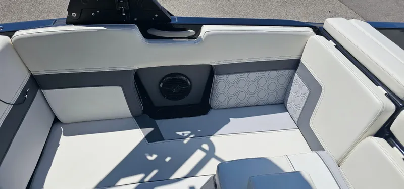 Slide: The Image of 2024 Heyday H22 boat interior with white and gray seating, featuring a built-in speaker. - 13