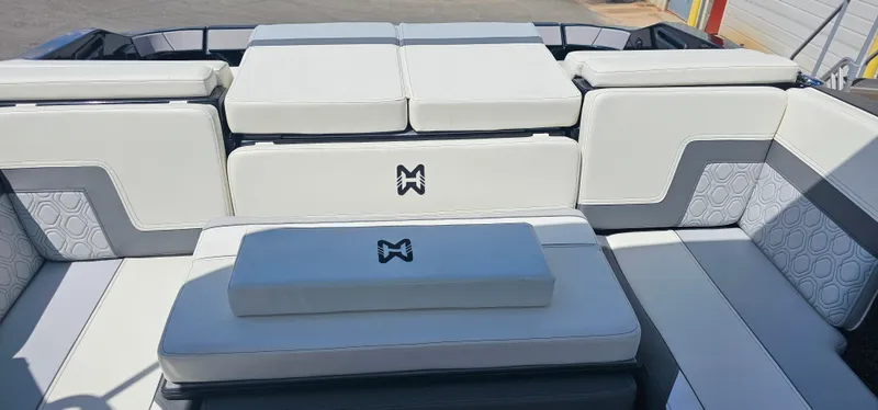 Slide: The Image of 2024 Heyday H22 boat interior with white cushioned seating and logo detail. - 14
