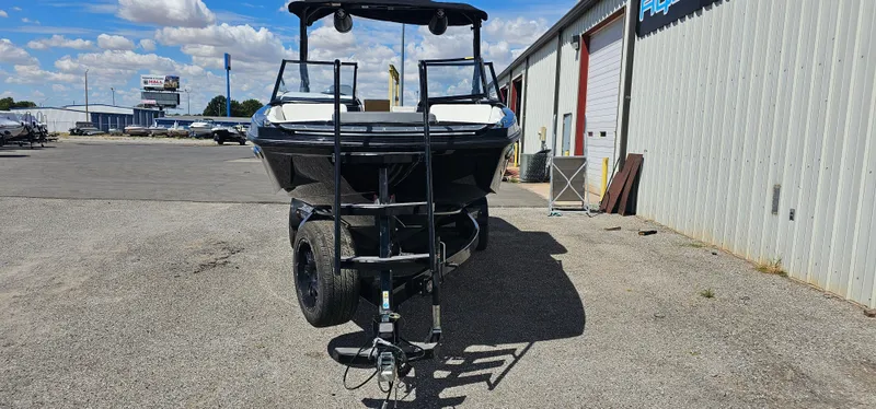 Slide: The Image of 2024 Heyday H22 boat on trailer, parked outside a warehouse under a blue sky. - 4