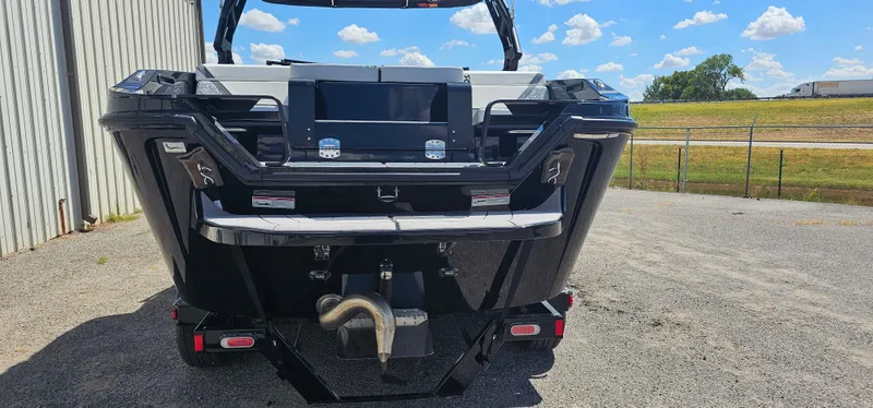 Slide: The Image of 2024 Heyday H22 boat rear view, parked outdoors under a clear blue sky. - 5