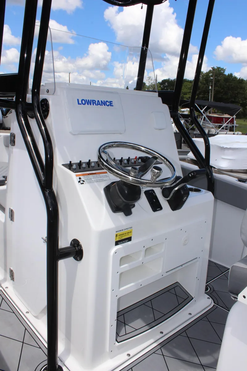 Slide: The Image of 2024 Clearwater 2200 WI Center Console boat dashboard with steering wheel and controls. - 15