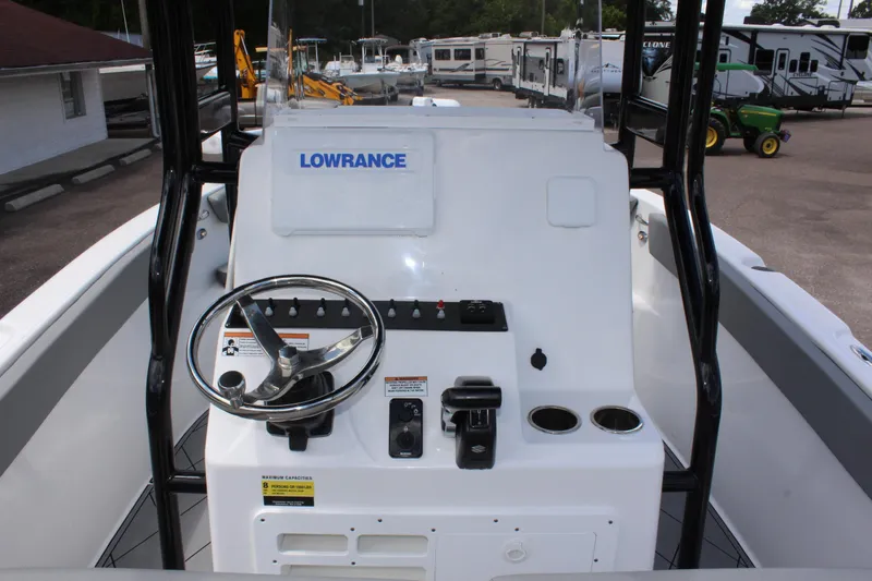 Slide: The Image of 2024 Clearwater 2200 WI Center Console boat dashboard with steering wheel and controls. - 16