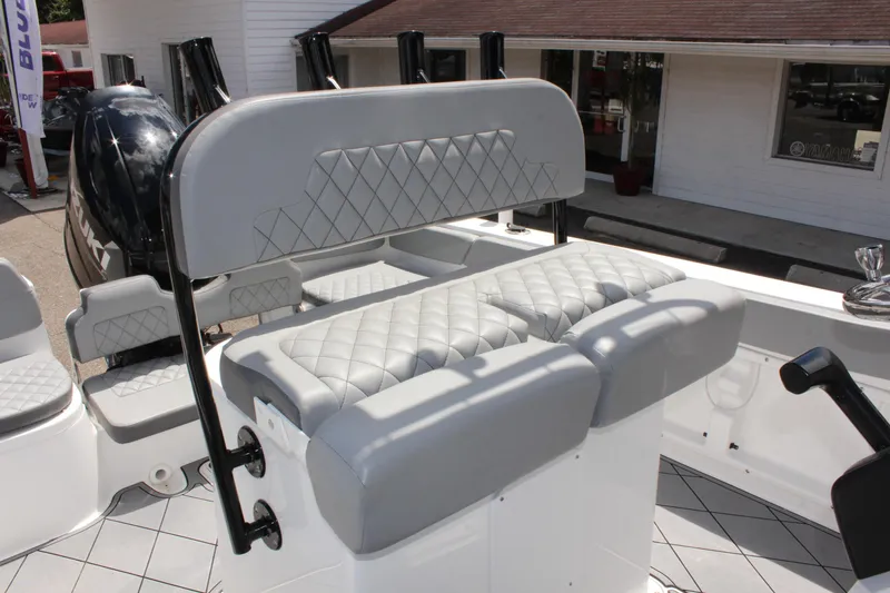 Slide: The Image of 2024 Clearwater 2200 WI Center Console boat with cushioned seating and modern design. - 17