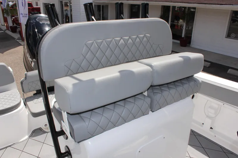 Slide: The Image of 2024 Clearwater 2200 WI Center Console boat with gray cushioned seating. - 18