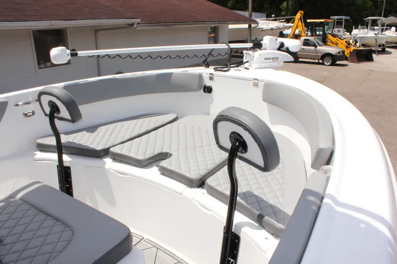Slide: The Image of 2024 Clearwater 2200 WI Center Console boat with cushioned seating and modern design. - 19