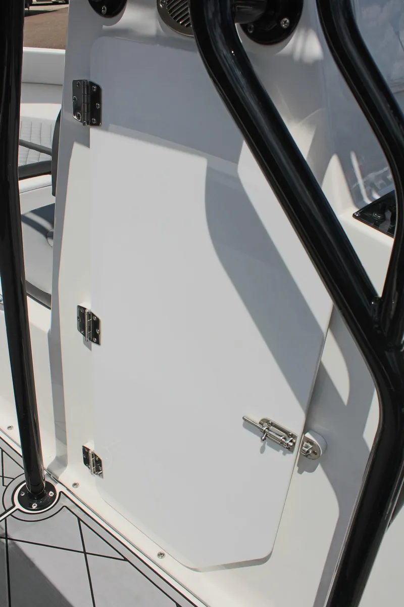 Slide: The Image of 2024 Clearwater 2200 WI Center Console boat door with black frame and hinges. - 21