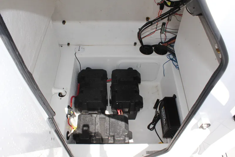 Slide: The Image of 2024 Clearwater 2200 WI Center Console battery compartment with wiring and components. - 23