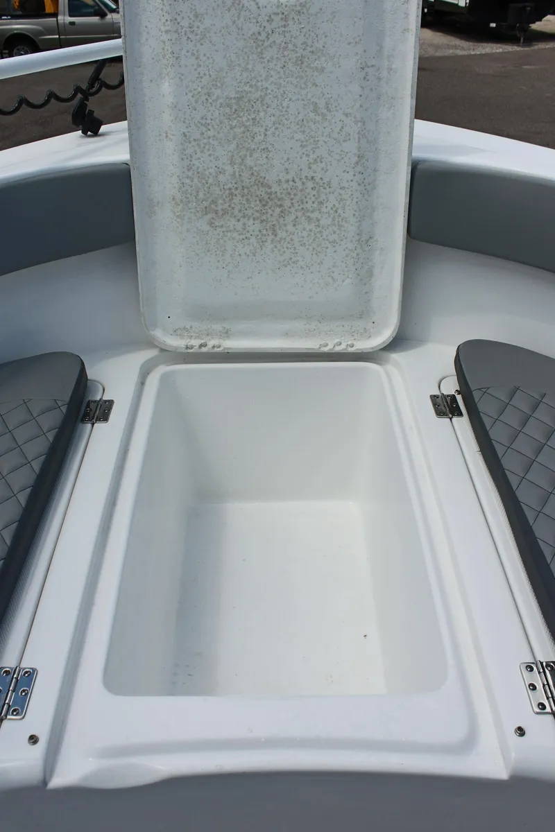 Slide: The Image of 2024 Clearwater 2200 WI Center Console boat storage compartment open. - 24