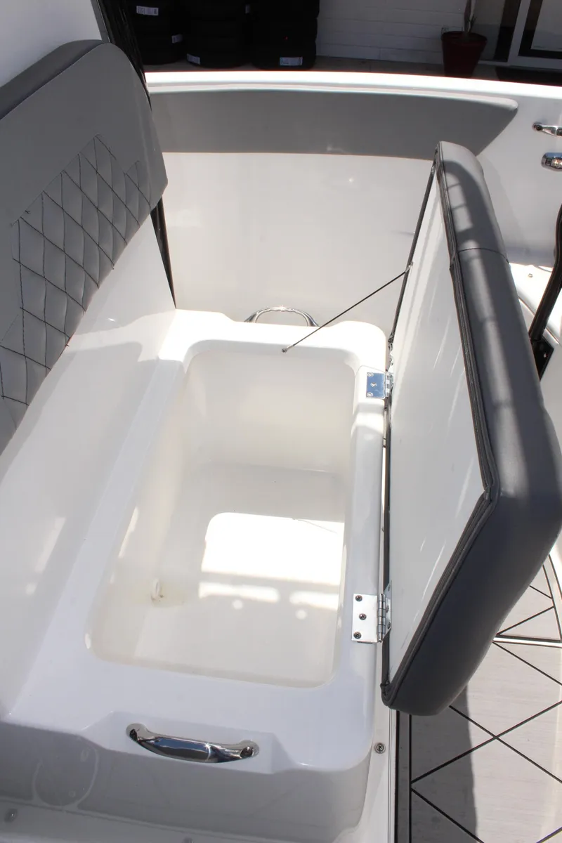 Slide: The Image of 2024 Clearwater 2200 WI Center Console boat with open storage compartment. - 30