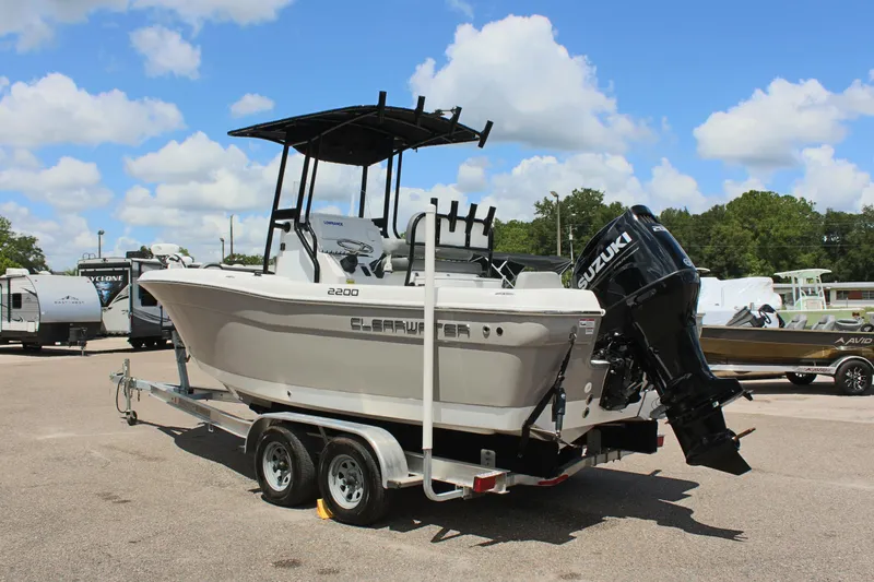 Slide: The Image of 2024 Clearwater 2200 WI Center Console boat on trailer, outdoors, sunny day. - 7