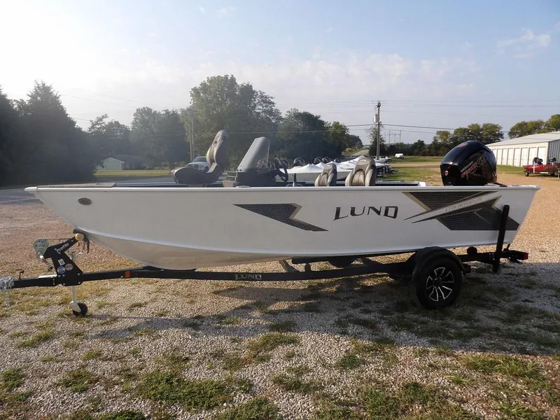 Slide: The Image of 2025 Lund 1775 Adventure SS boat on trailer, parked outdoors. - 1