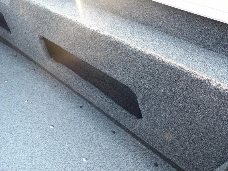 Slide: The Image of 2025 Lund 1775 Adventure SS boat interior with textured flooring and storage compartment. - 17