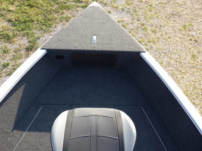 Slide: The Image of 2025 Lund 1775 Adventure SS boat interior with gray carpet and seating. - 20