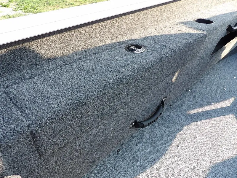 Slide: The Image of 2025 Lund 1775 Adventure SS boat interior with gray carpeted storage compartment. - 22