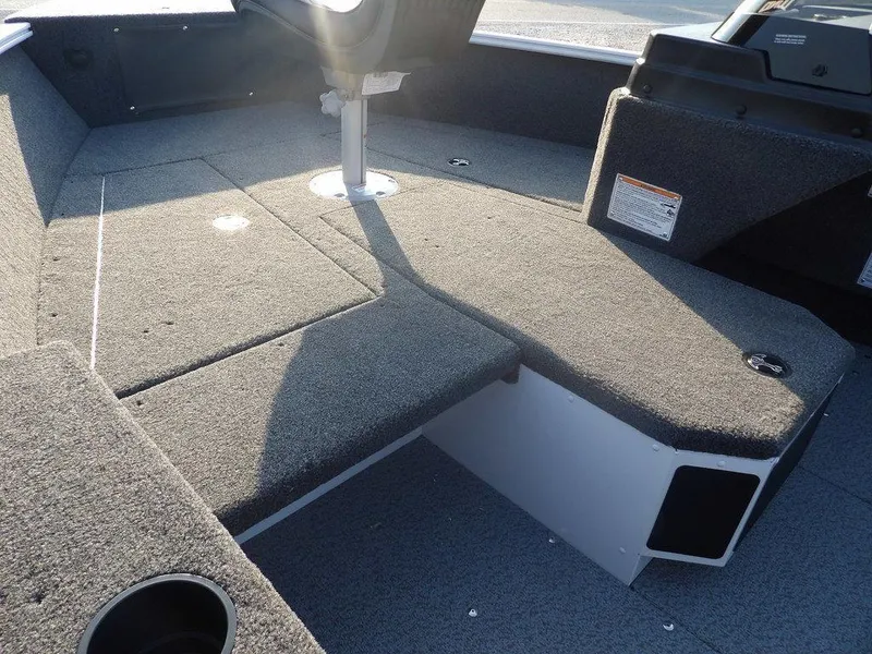 Slide: The Image of 2025 Lund 1775 Adventure SS boat interior with carpeted deck and seating. - 25