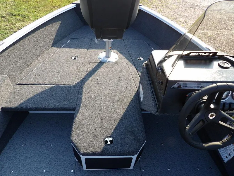 Slide: The Image of 2025 Lund 1775 Adventure SS boat interior with steering console and seating. - 3