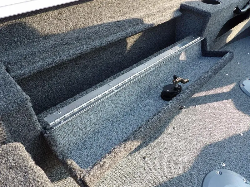 Slide: The Image of 2025 Lund 1775 Adventure SS boat interior with carpeted storage area and mounting rail. - 35
