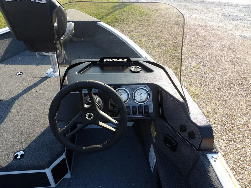 Slide: The Image of 2025 Lund 1775 Adventure SS boat dashboard with steering wheel and gauges. - 36