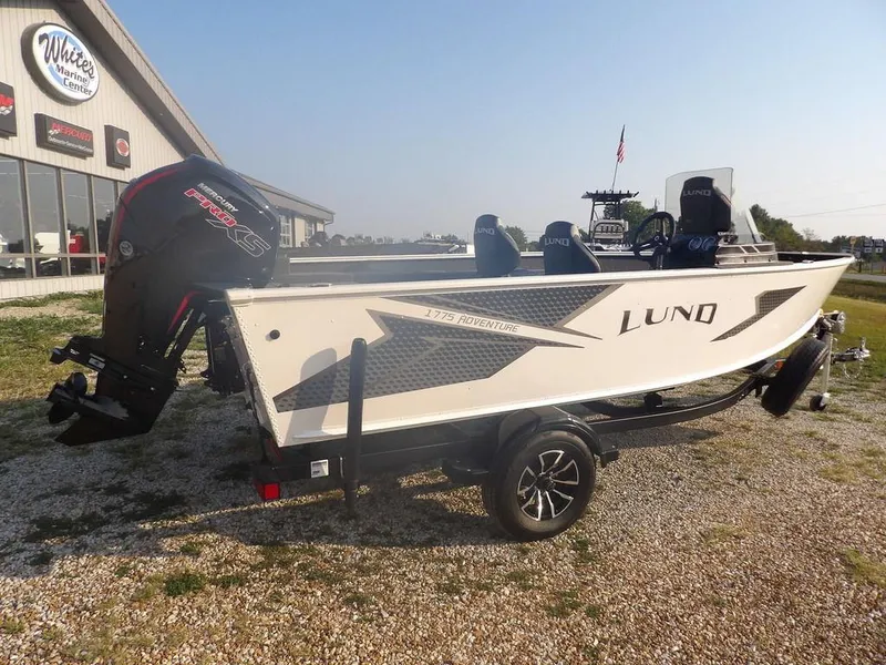 Slide: The Image of 2025 Lund 1775 Adventure SS boat on trailer, parked outside dealership. - 39