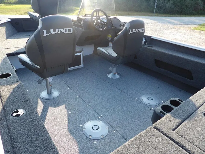 Slide: The Image of 2025 Lund 1775 Adventure SS boat interior with two seats and steering console. - 6