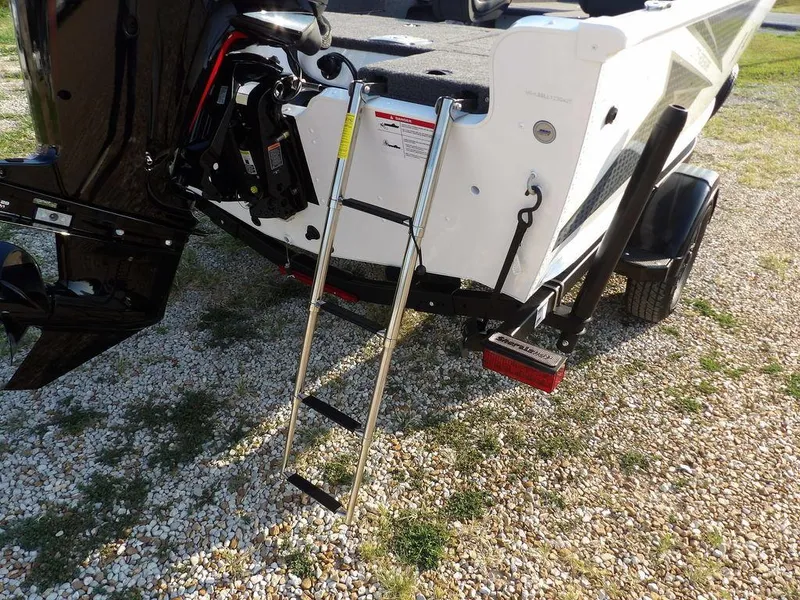 Slide: The Image of 2025 Lund 1775 Adventure SS boat with ladder on gravel surface. - 7