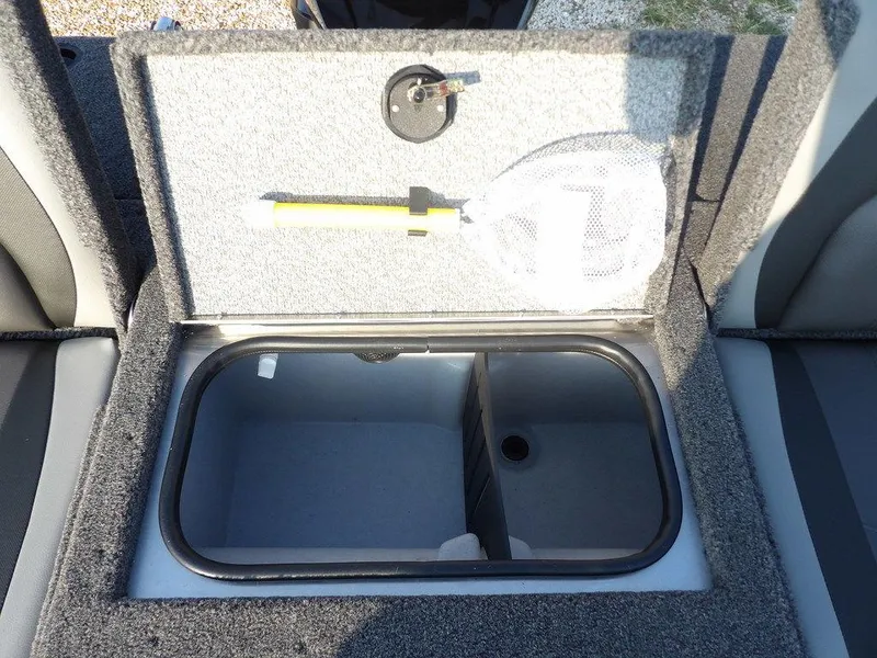 Slide: The Image of 2025 Lund 1775 Adventure SS boat storage compartment with open lid and fishing net. - 9
