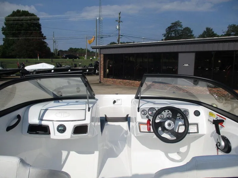 Slide: The Image of 2023 Tahoe 185 S boat cockpit with steering wheel and dashboard controls. - 10