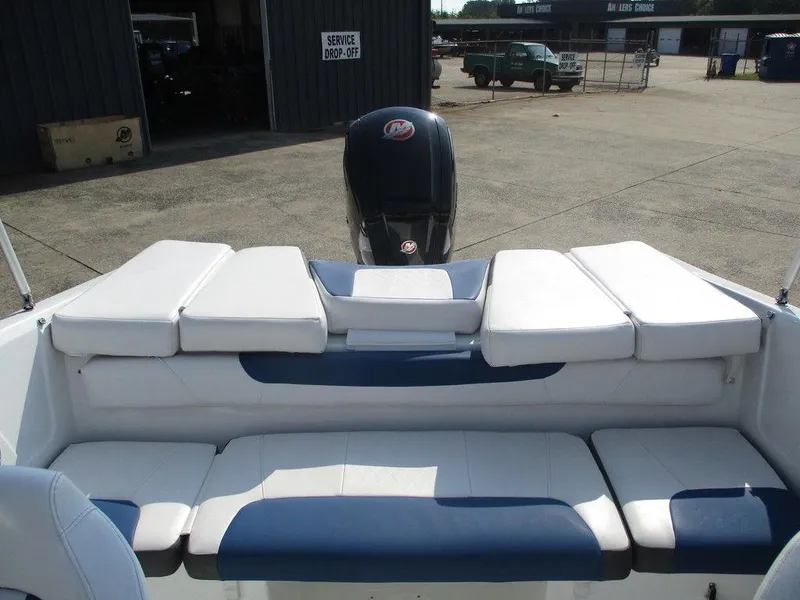 Slide: The Image of 2023 Tahoe 185 S boat interior with cushioned seating and outboard motor. - 6