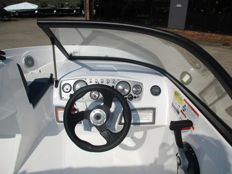 Slide: The Image of 2023 Tahoe 185 S boat dashboard with steering wheel and control panel. - 7