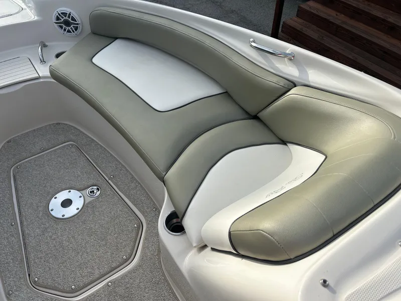 Slide: The Image of 2007 Sea Ray 240 Sundeck boat interior with cushioned seating and carpeted flooring. - 13