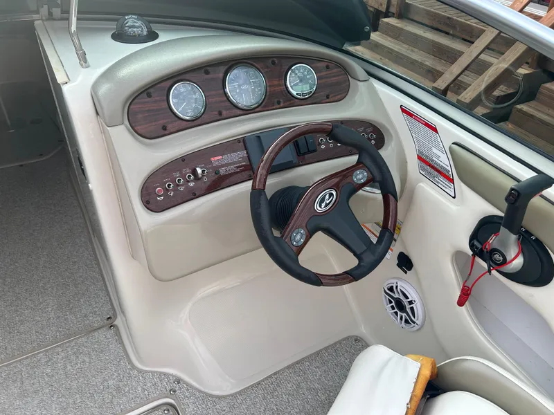 Slide: The Image of 2007 Sea Ray 240 Sundeck dashboard with steering wheel and instrument panel. - 6