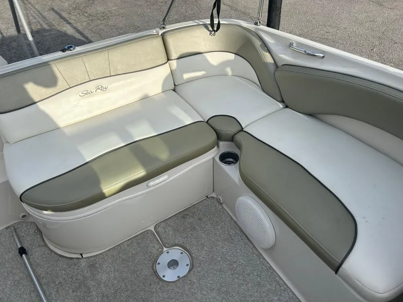 Slide: The Image of 2007 Sea Ray 240 Sundeck interior seating with beige and white upholstery. - 7