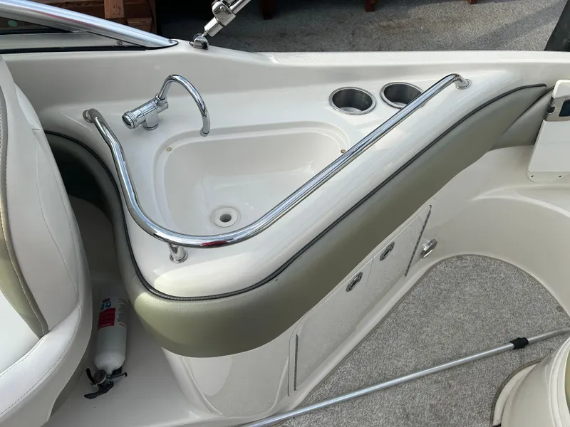 Slide: The Image of 2007 Sea Ray 240 Sundeck interior with sink and cup holders. - 8