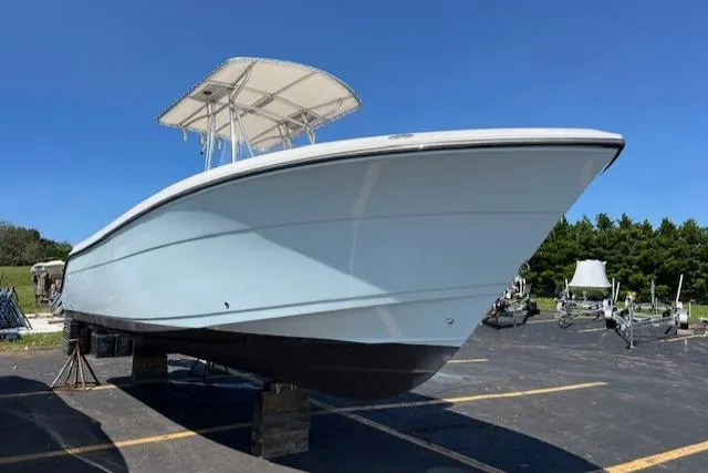 Slide: The Image of 2020 Cobia 237 Center Console boat on display in a parking lot. - 1