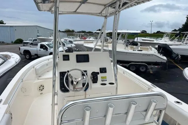 Slide: The Image of 2020 Cobia 237 Center Console boat with steering wheel and navigation equipment. - 13