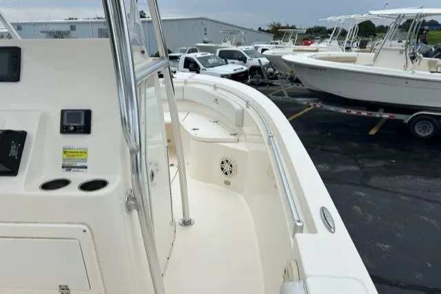 Slide: The Image of 2020 Cobia 237 Center Console boat, white interior, docked with other boats. - 14