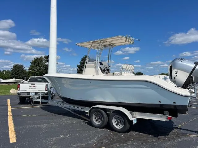 Slide: The Image of 2020 Cobia 237 Center Console boat on trailer, parked in sunny lot. - 3