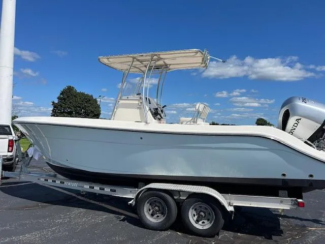 Slide: The Image of 2020 Cobia 237 Center Console boat on trailer under blue sky. - 4