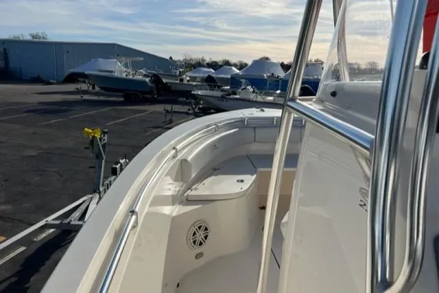 Slide: The Image of 2020 Cobia 237 Center Console boat docked, showcasing sleek design and spacious deck. - 5