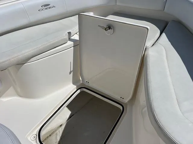 Slide: The Image of 2020 Cobia 237 Center Console boat storage compartment with open hatch. - 8
